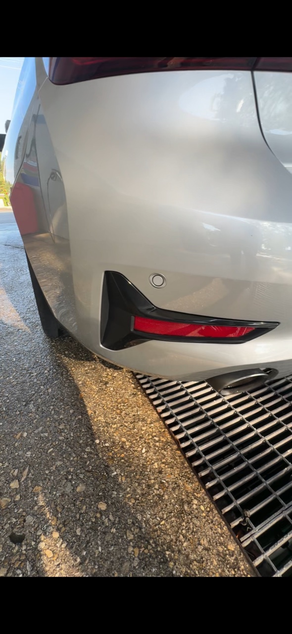Polished sedan rear paint reflecting light