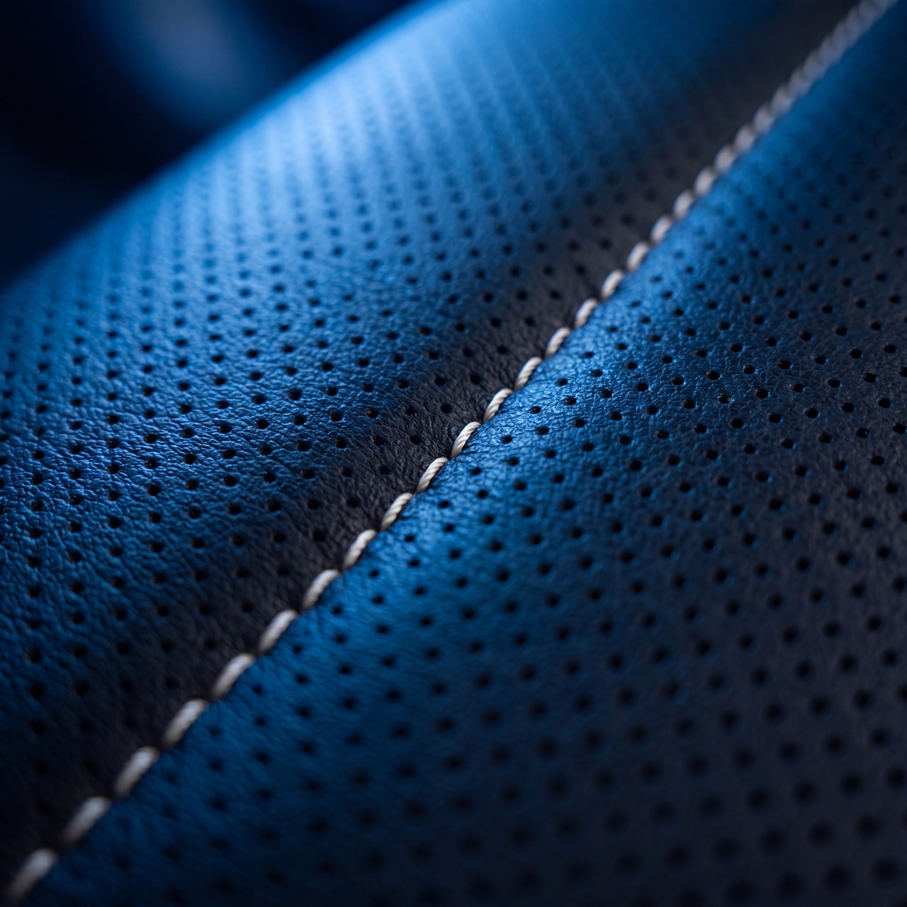 Macro of perforated leather with contrast stitch
