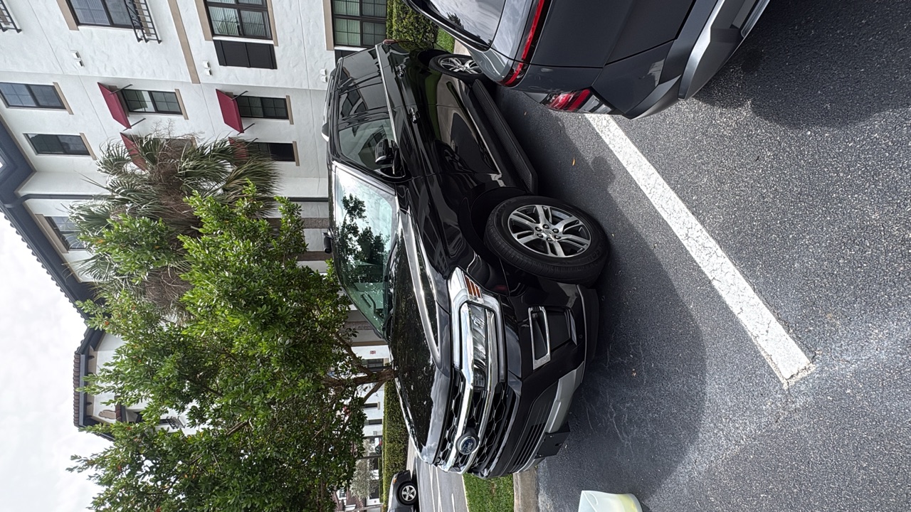 Black Ford Explorer freshly detailed in apartment driveway